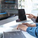 Professional Developer programmer cooperation meeting and brainstorming and programming in website working a software outsourcing and coding technology, writing codes and database