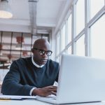 Businessman working on laptop in office