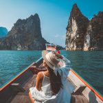 Traveler asian woman relax and travel on Thai longtail boat in Ratchaprapha Dam at Khao Sok National Park Surat Thani Thailand