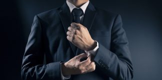 Businessman Fixing Cufflinks his Suit