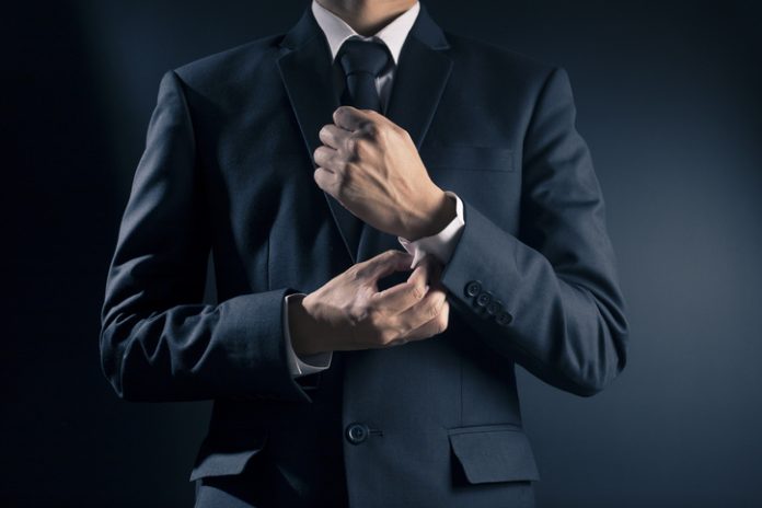 Businessman Fixing Cufflinks his Suit