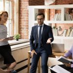 Diverse employees listen to leader