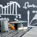 black graduation cap on computer keyboard