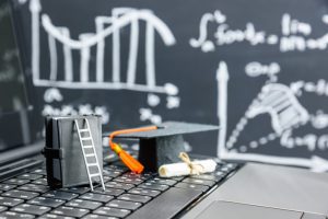 black graduation cap on computer keyboard