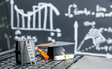 black graduation cap on computer keyboard