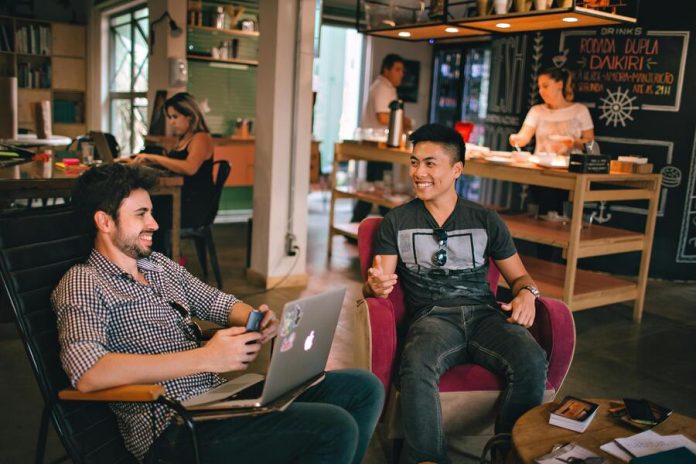 Gentlemen having a conversation while sitting on chairs