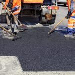 The workers are asphalt paving the roads.