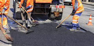 The workers are asphalt paving the roads.