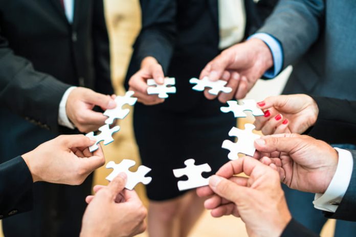 People assembling a jigsaw puzzle