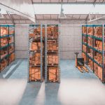 Interior of a warehouse with shelves and pallets full of different package