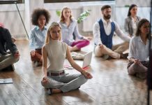 Employees meditating at the workplace