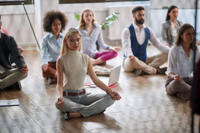 Employees meditating at the workplace