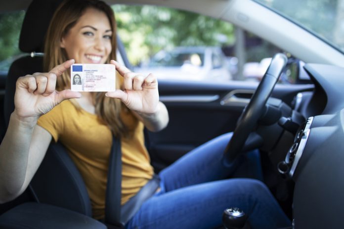 Female holding a driver license