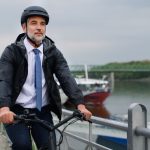 A businessman commuter on the way to work, riding bike in city, sustainable lifestyle concept.