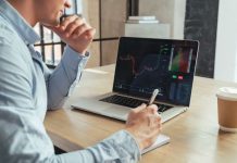 Businessman looking at live trading on computer