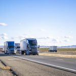 Semi trailers running on the divided highway road