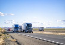 Semi trailers running on the divided highway road