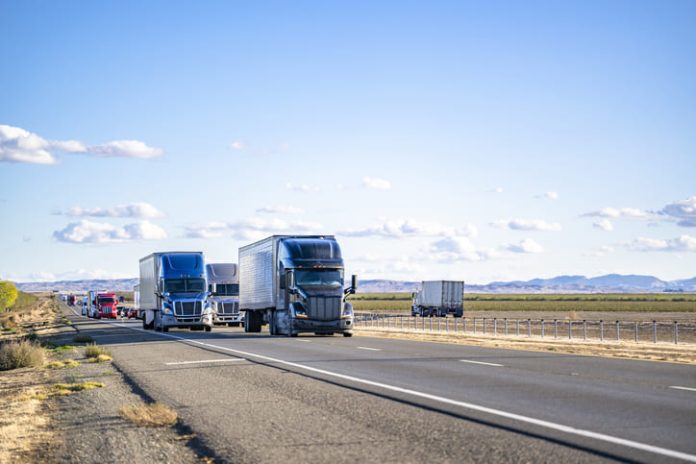 Semi trailers running on the divided highway road