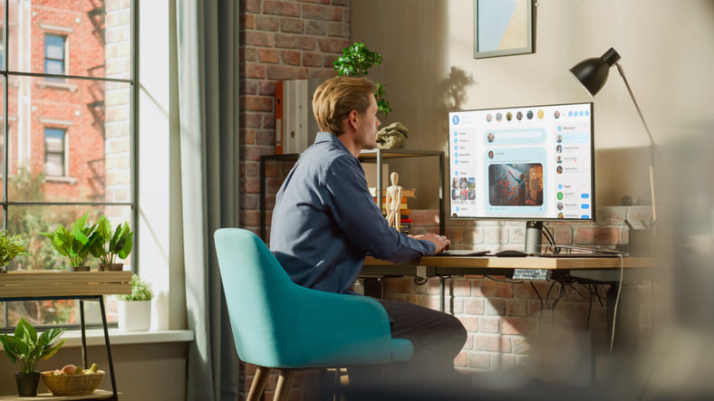 Male businessman monitoring social media on computer