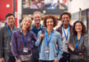 Portrait Of Group Of Smiling Mature Students Standing In College Hall