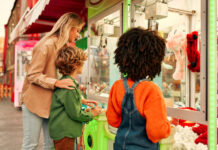 Children with their mother playing claw machine