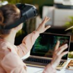 Female with laptop and vr gear in modern office