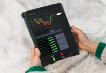 Trader holding a tablet for trading