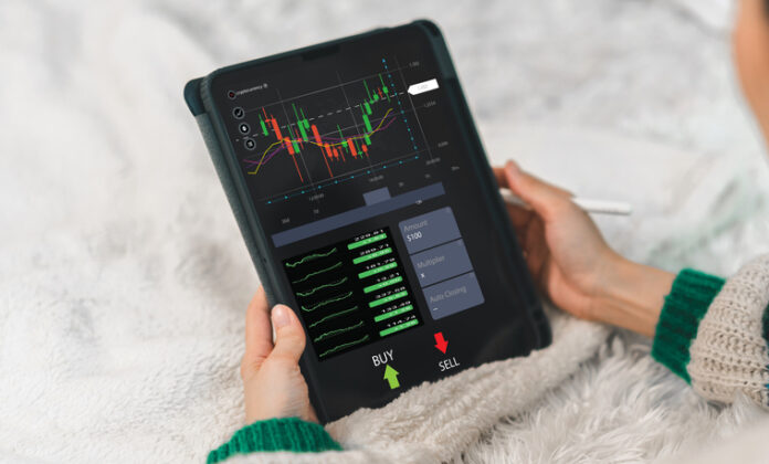 Trader holding a tablet for trading