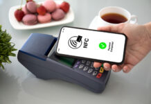 Female hands phone pay wireless technology nfc via pos terminal