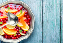 Alcoholic cocktail with pieces of fruit and berries