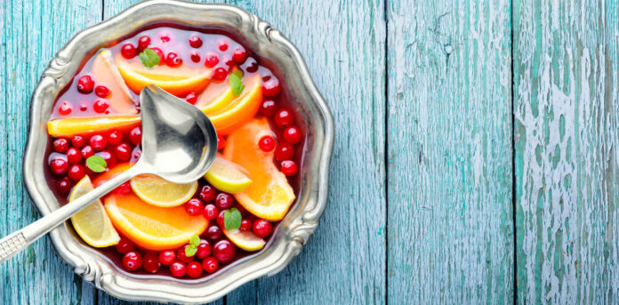 Alcoholic cocktail with pieces of fruit and berries