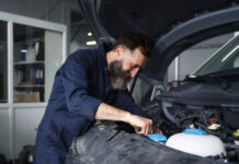 Male mechanic working on car in the auto repair shop