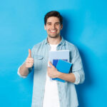 Young man student with notebooks