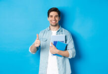 Young man student with notebooks