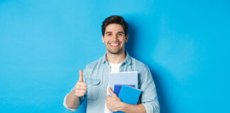 Young man student with notebooks