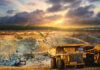 Yellow dump truck loading minerals copper, silver, gold, and other at mining quarry.