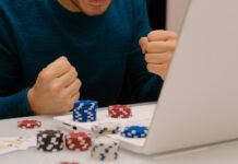 Gamer man playing with his laptop from home to casino games