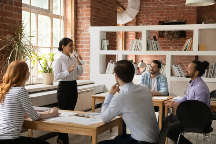 Female employee sharing stories to her colleague