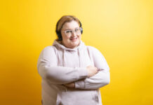 Portrait of sporty caucasian fat woman with headphones