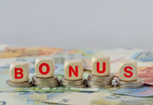 Wooden blocks with the word Bonus on coins and banknotes