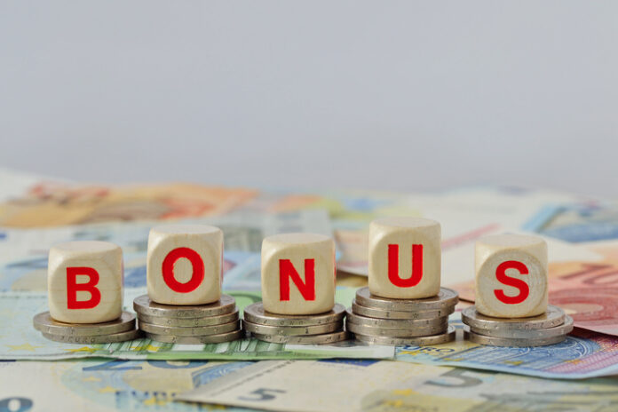 Wooden blocks with the word Bonus on coins and banknotes