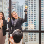 Business woman holding award trophy