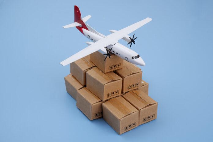 Airplane model on many shipping carton boxes on blue background