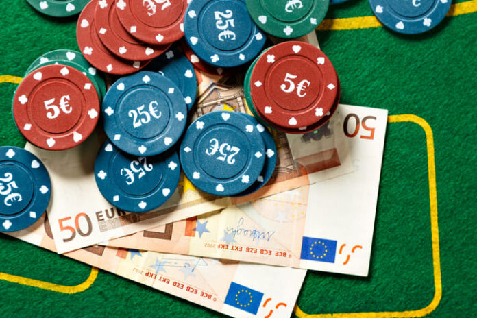 Poker chips and bills at a poker table