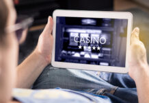 Man playing in an online casino with tablet