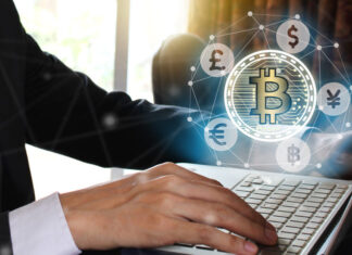 Businessman use Laptop with virtual screen bitcoin and fintech