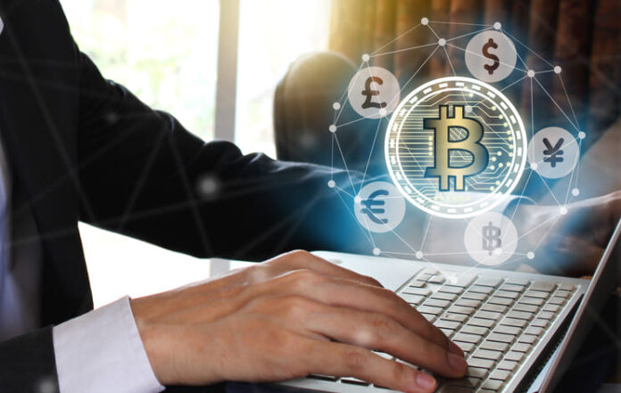 Businessman use Laptop with virtual screen bitcoin and fintech