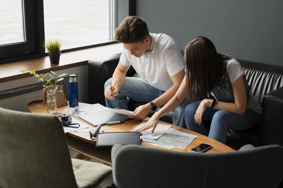 Medium shot people planning trip indoors 