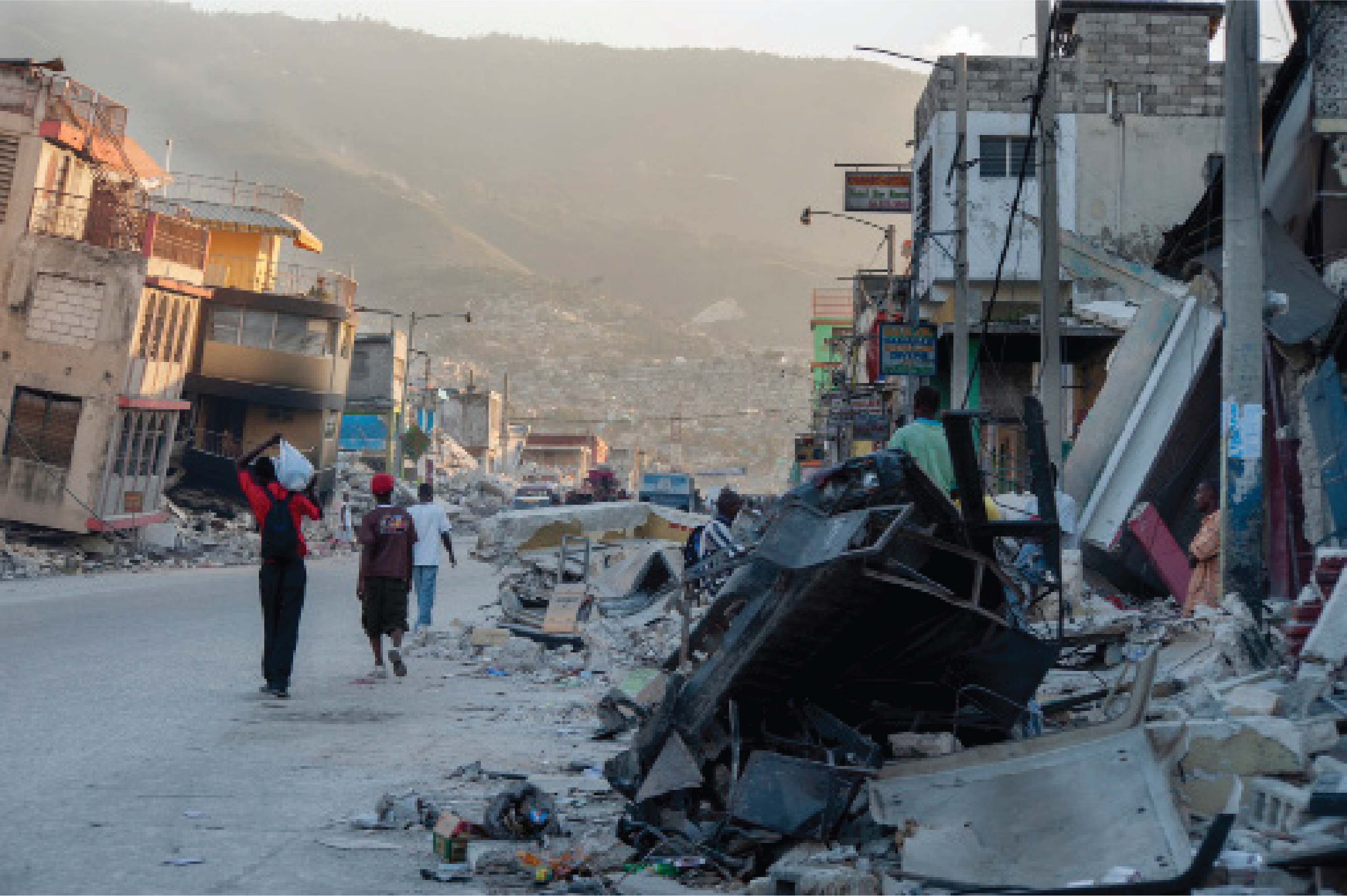 People walk past devastation on Grand Rue