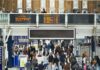 People walking through a train station